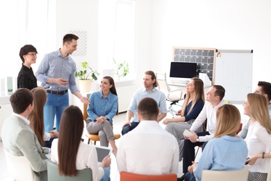 Photo of Young people having business training in office