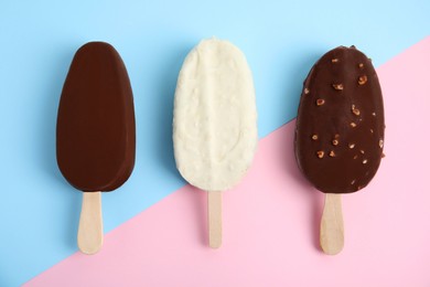 Photo of Glazed ice cream bars on color background, flat lay