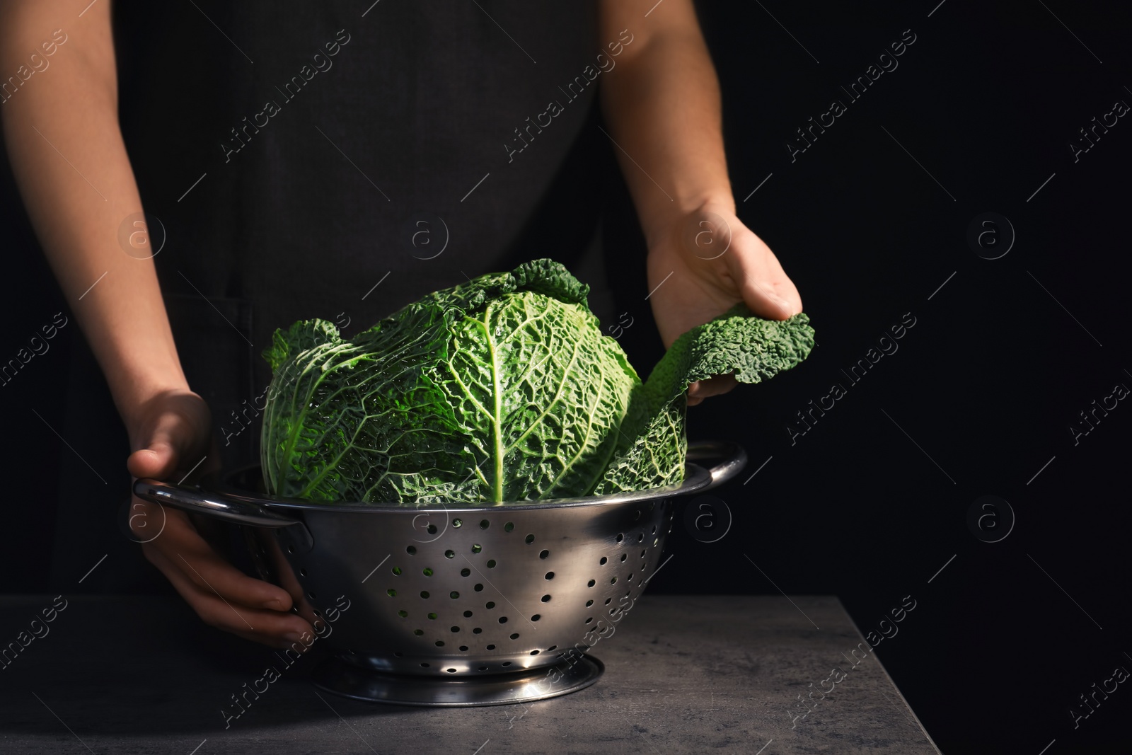 Photo of Woman with fresh savoy cabbage at table