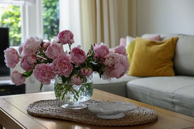 Photo of Beautiful pink peonies in vase on table at home, space for text. Interior design