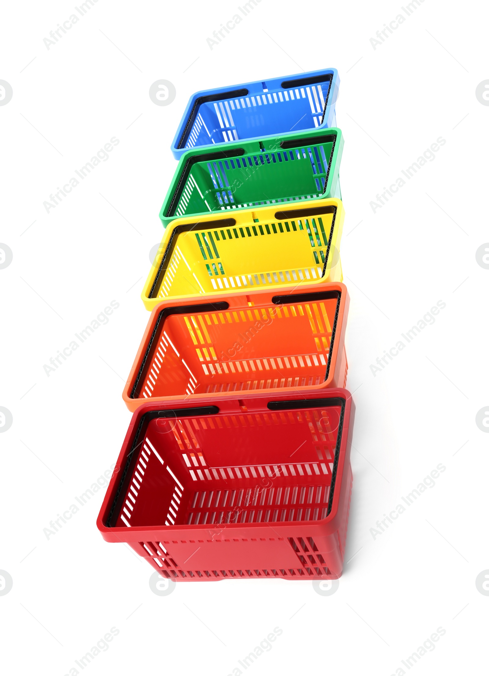 Photo of Colorful plastic shopping baskets on white background