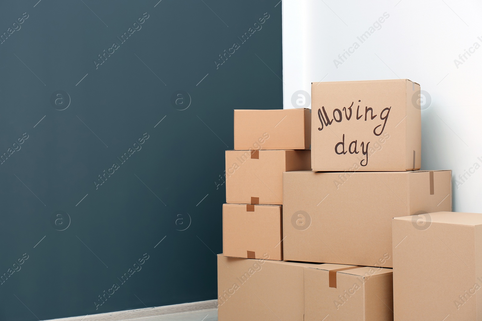 Photo of Pile of moving boxes in empty room