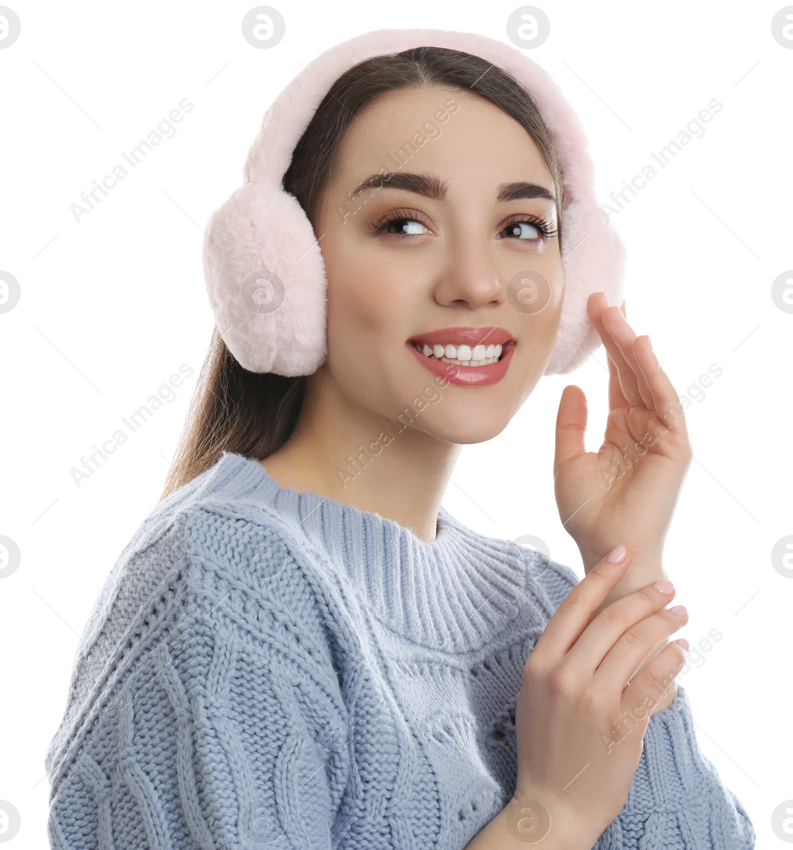 Photo of Beautiful young woman wearing earmuffs on white background