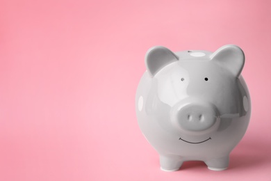 Photo of Gray piggy bank on color background. Money saving