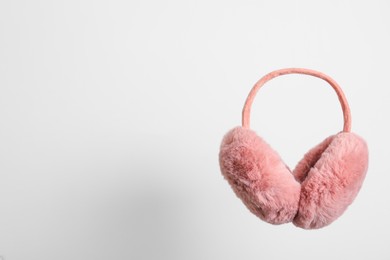 Photo of Stylish winter earmuffs on white background, space for text