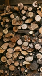 Stacked firewood indoors. Heating house in winter