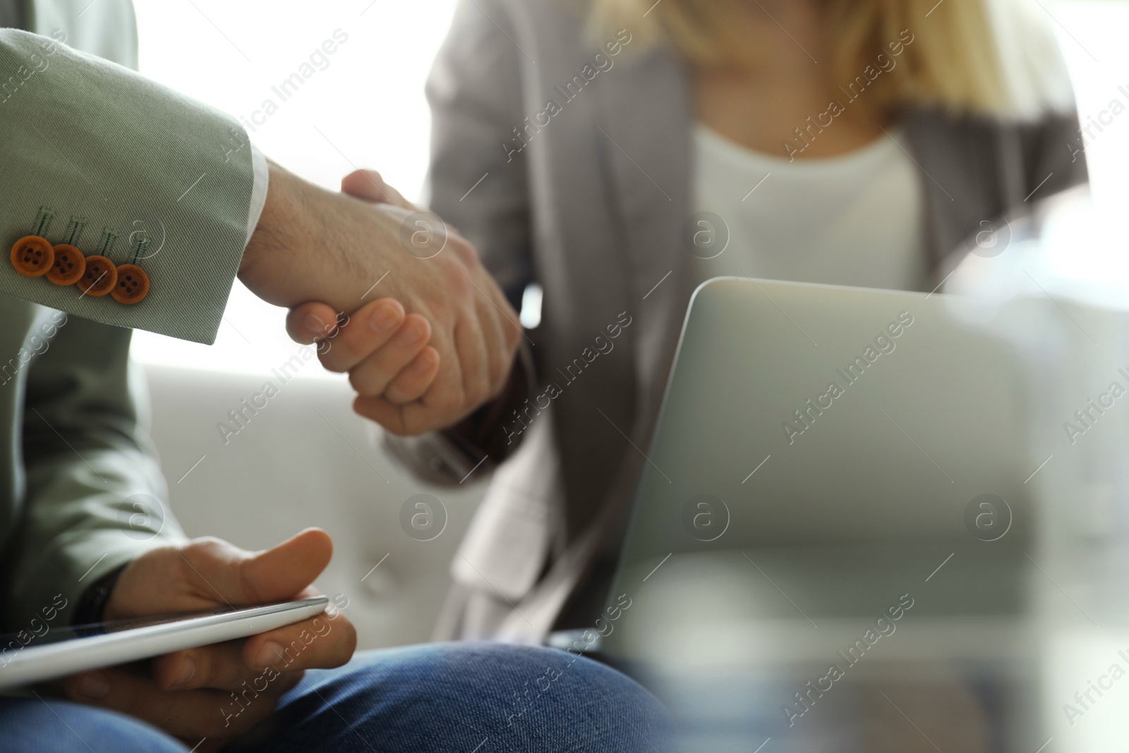 Photo of Business partners shaking hands after meeting, closeup