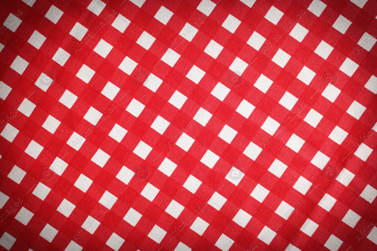 Image of Red and white tablecloth as background, vignette effect