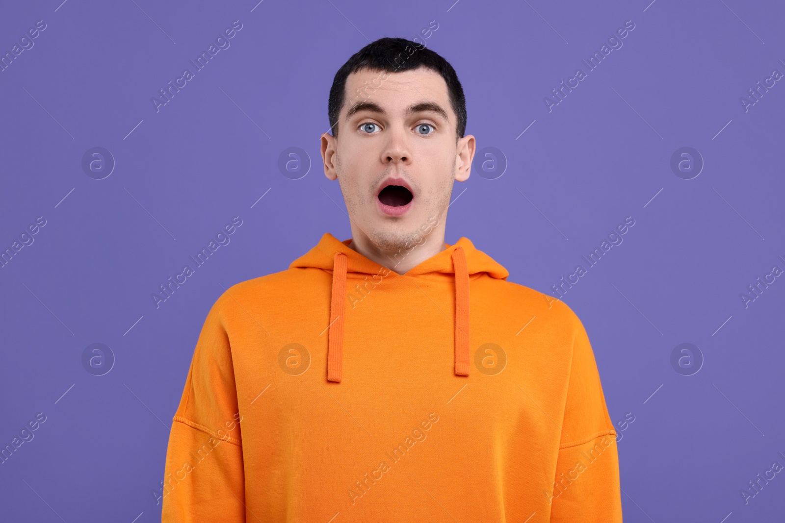 Photo of Portrait of surprised man on purple background