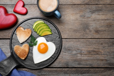 Romantic breakfast on wooden table, flat lay with space for text. Valentine's day celebration