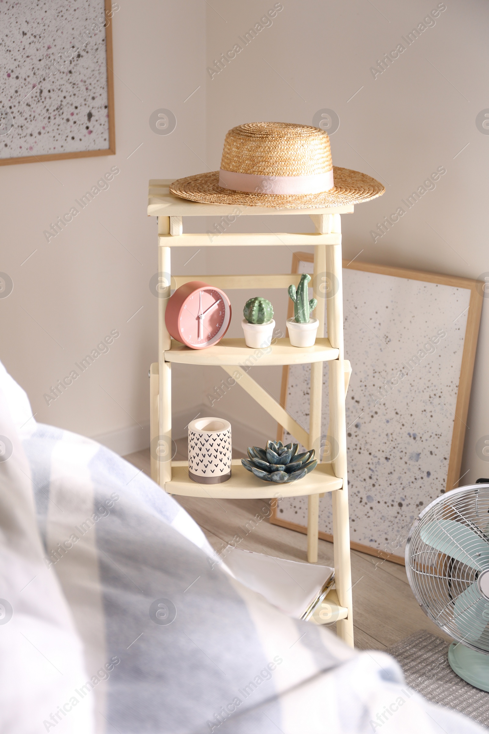 Photo of Decorative ladder with different stuff in stylish bedroom. Idea for interior design