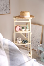 Decorative ladder with different stuff in stylish bedroom. Idea for interior design