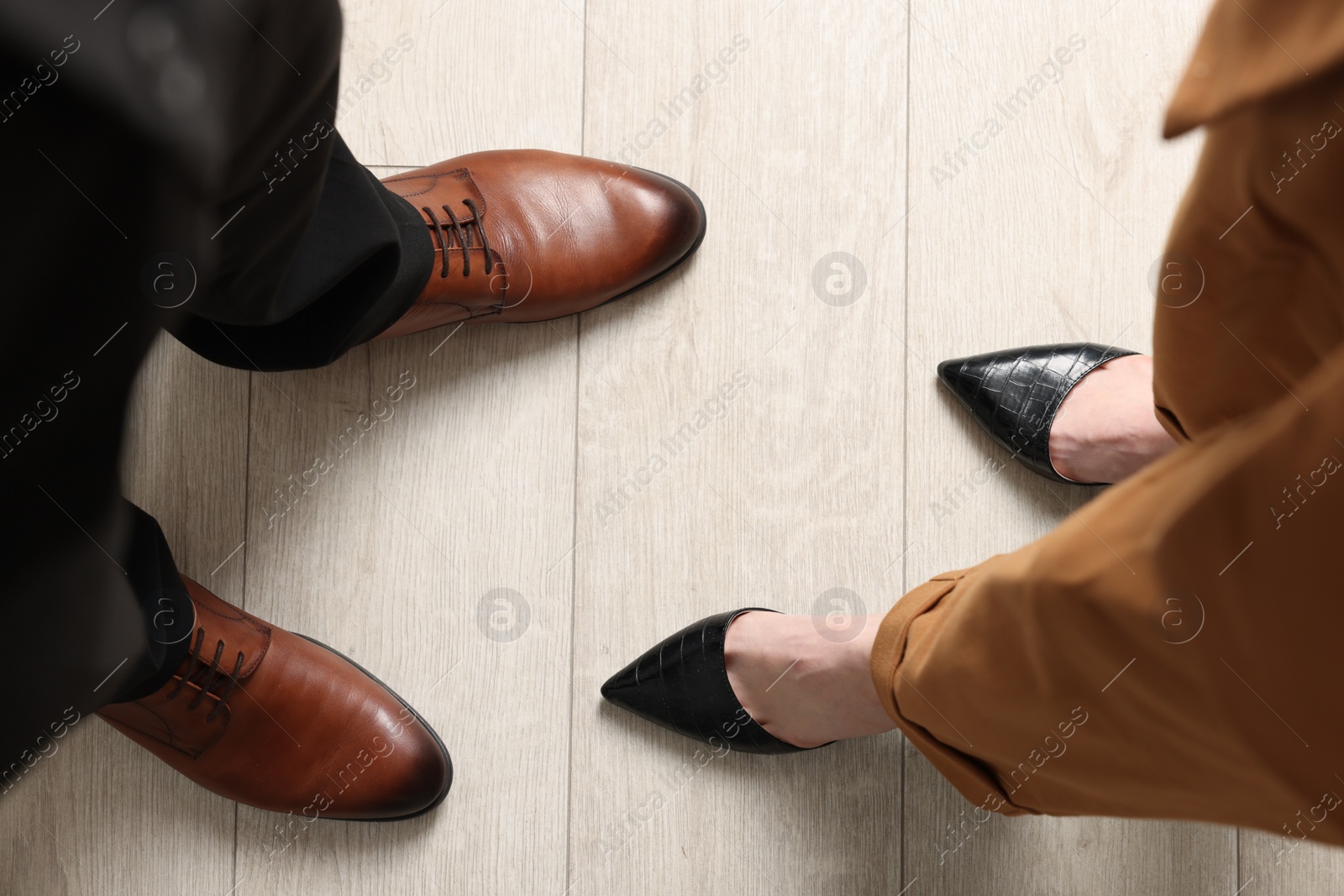 Photo of Businessman and businesswoman in elegant shoes on floor, above view