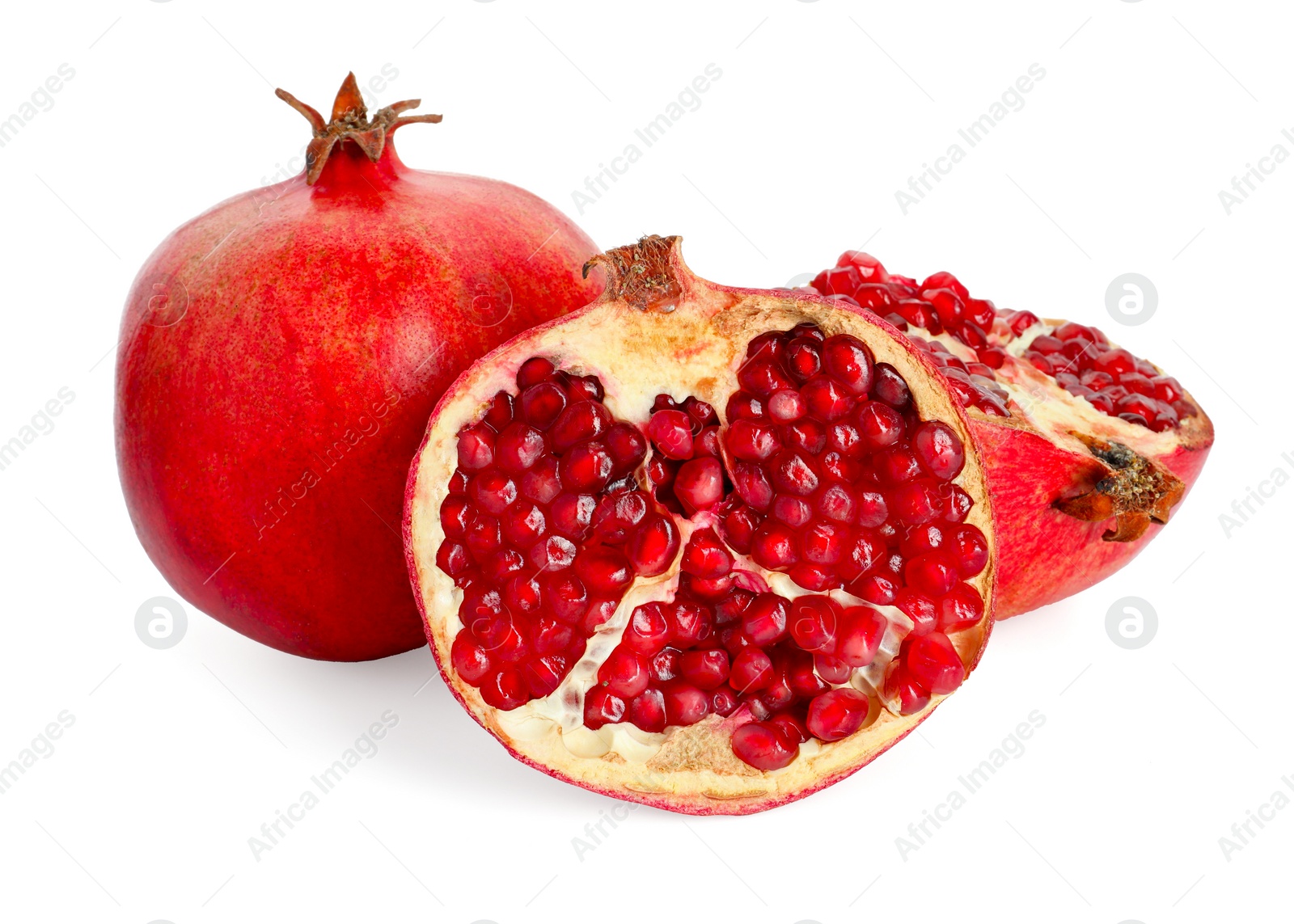 Photo of Halves and whole pomegranates isolated on white