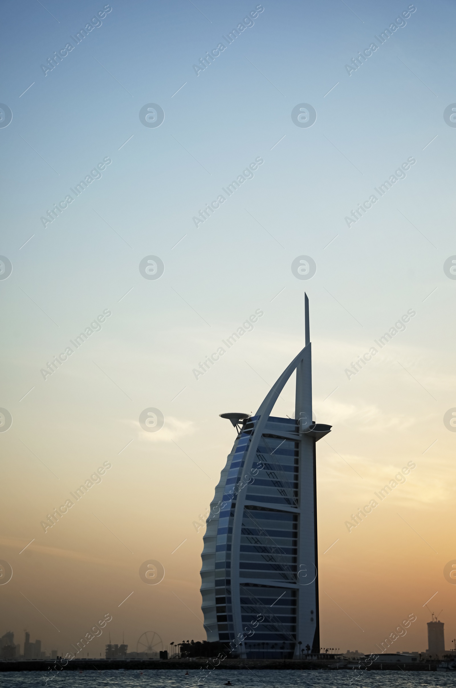 Photo of DUBAI, UNITED ARAB EMIRATES - NOVEMBER 03, 2018: Beautiful view of famous Burj Al Arab and amazing sunset sky