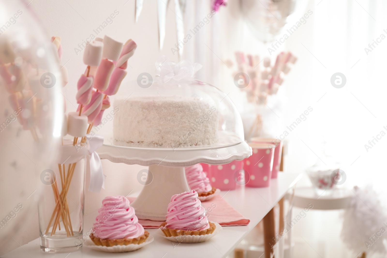 Photo of Tasty birthday cake and sweets on table indoors