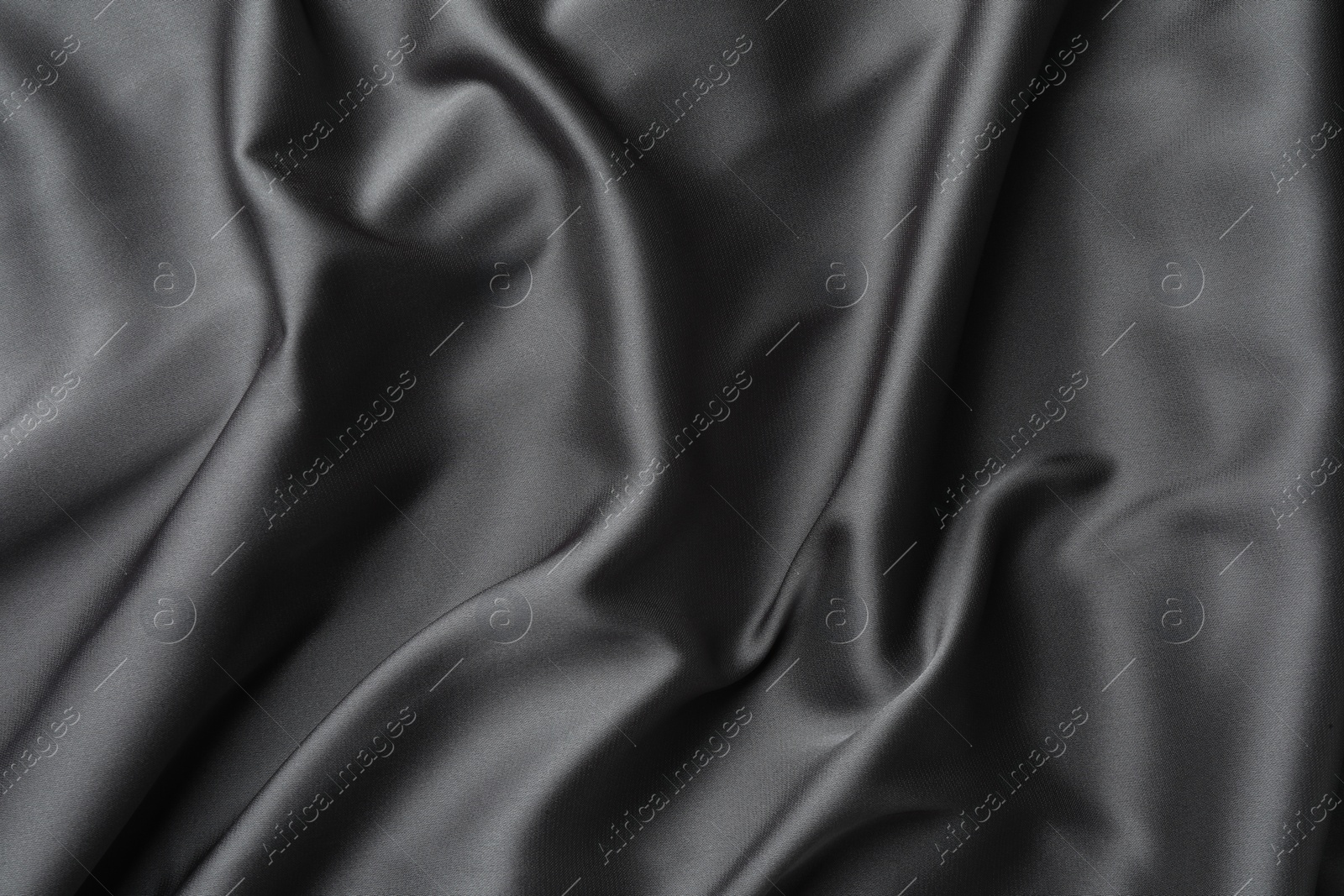 Photo of Texture of black crumpled silk fabric as background, top view
