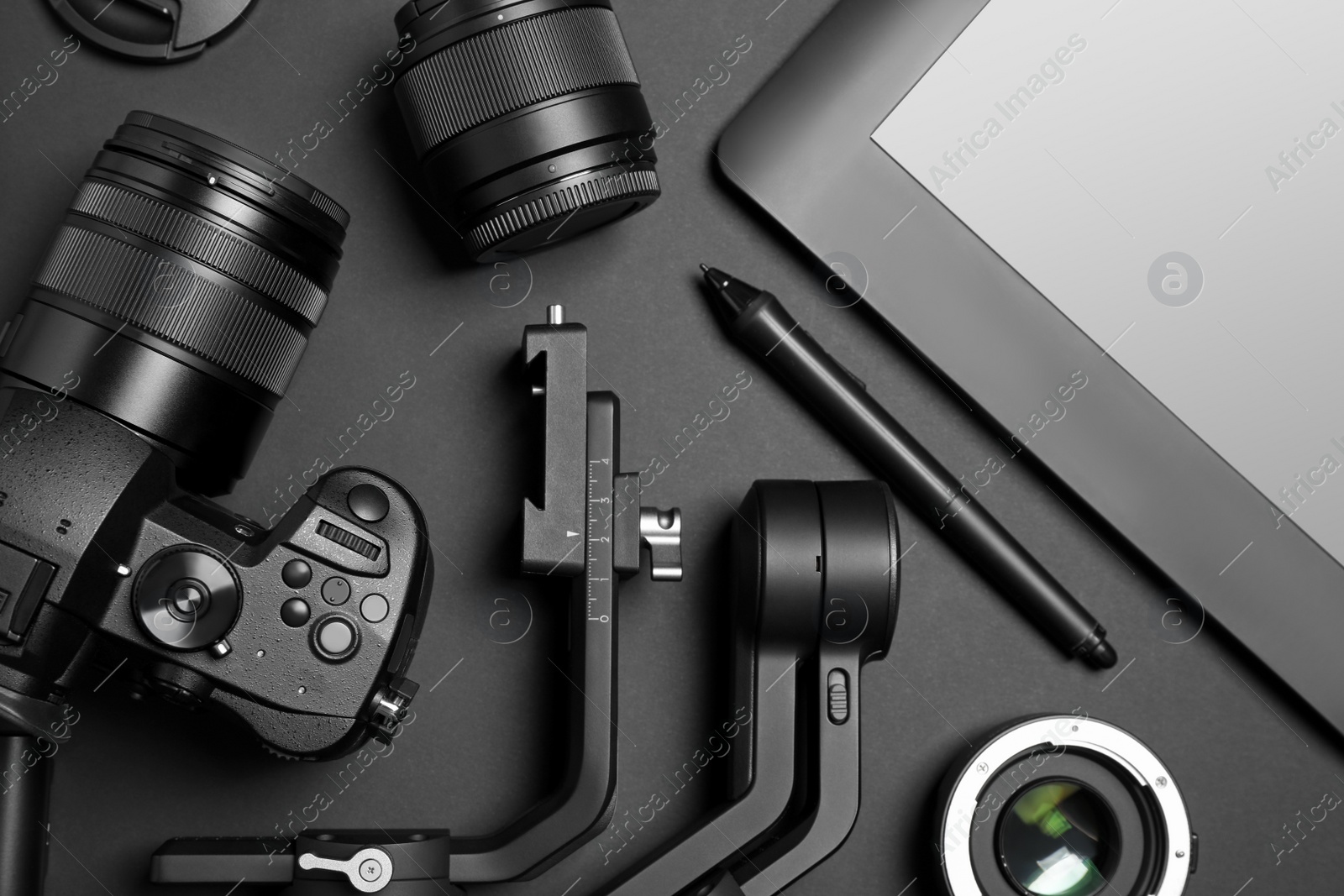 Photo of Camera and video production equipment on black background, flat lay