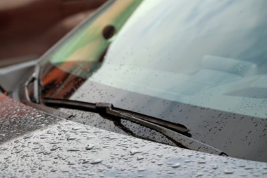Photo of Car wipers and water drops on windshield glass, closeup