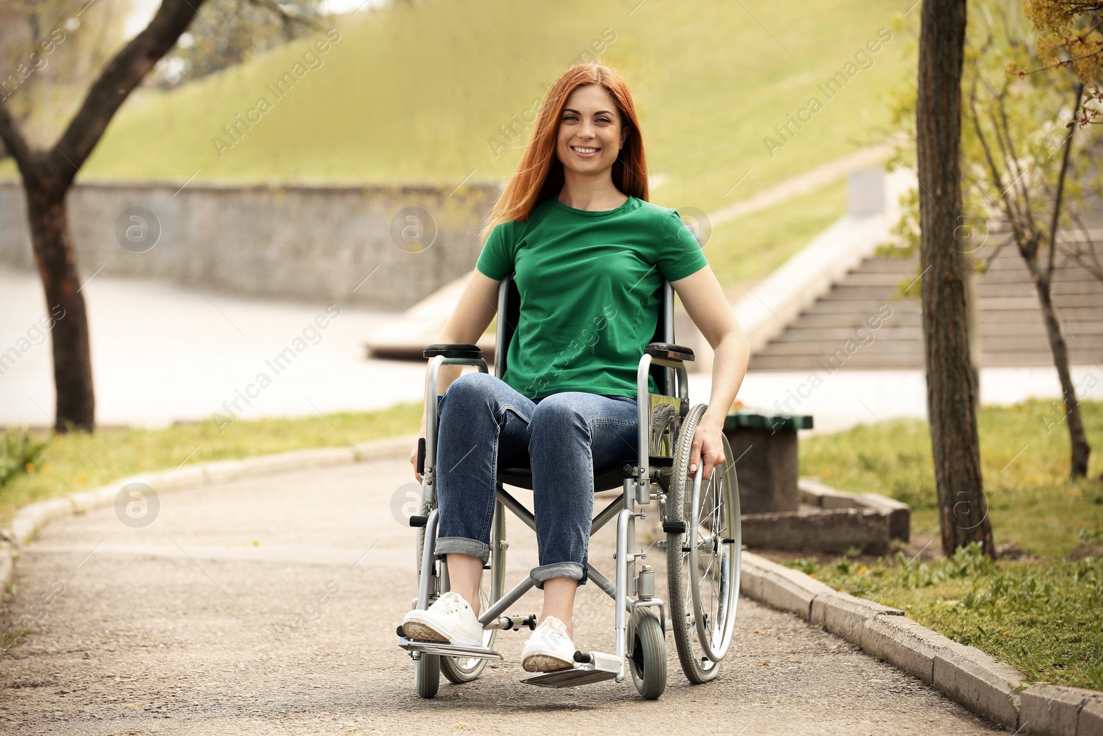 Photo of Young woman in wheelchair at park on sunny day
