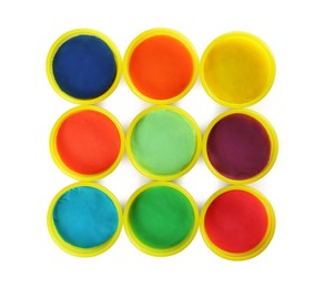Photo of Plastic containers with colorful play dough on white background, top view