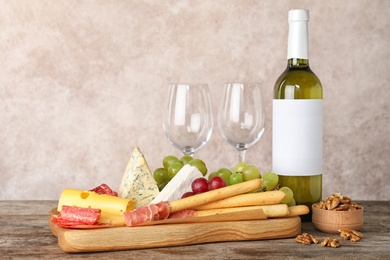 Photo of Composition with wine and snacks on table. Space for text