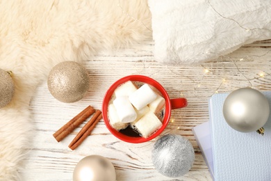 Photo of Flat lay composition with cup of hot winter drink on wooden background. Cozy season