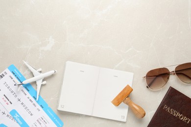 Photo of Flat lay composition with passports, stamp and flight tickets on light table, space for text