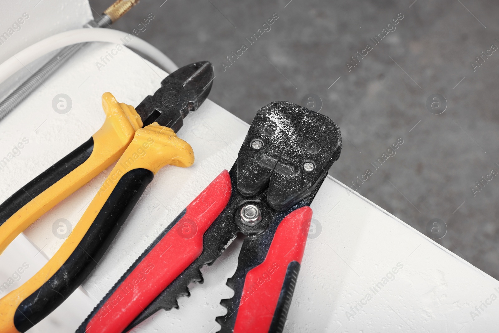 Photo of Different cutting pliers indoors, closeup. Electrician's tool