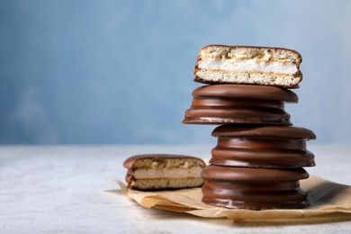 Photo of Stack of tasty choco pies on grey table. Space for text