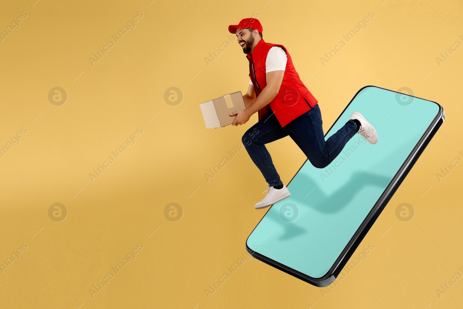 Image of Courier with parcel jumping out from huge smartphone on golden background. Delivery service. Space for text