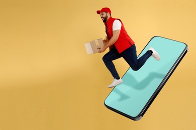 Image of Courier with parcel jumping out from huge smartphone on golden background. Delivery service. Space for text