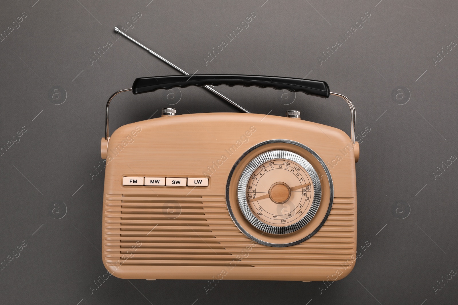 Photo of Retro radio receiver on grey background, top view