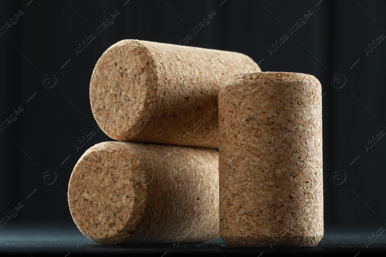 Photo of Corks of wine bottles on grey table, closeup