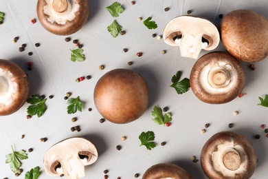 Photo of Flat lay composition with fresh champignon mushrooms on grey background