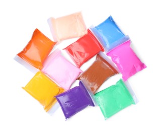 Many packages of different colorful plasticine on white background, top view