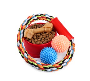 Photo of Pet dry food in bowl, treats and toys on white background. Shop assortment