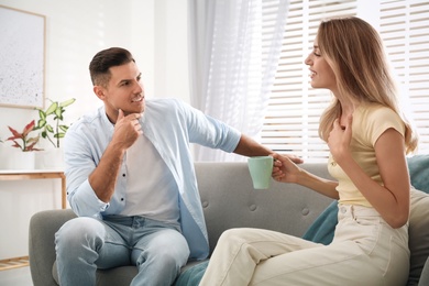 Man and woman talking in living room