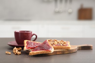 Delicious toasts and cup of drink on counter in kitchen