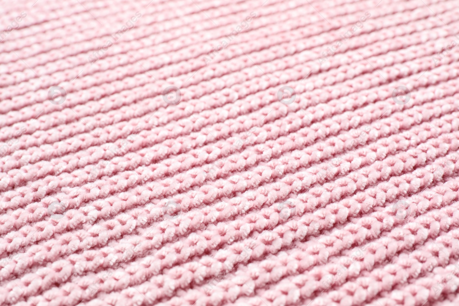 Photo of Pink winter sweater as background, closeup view