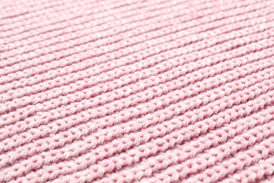 Photo of Pink winter sweater as background, closeup view