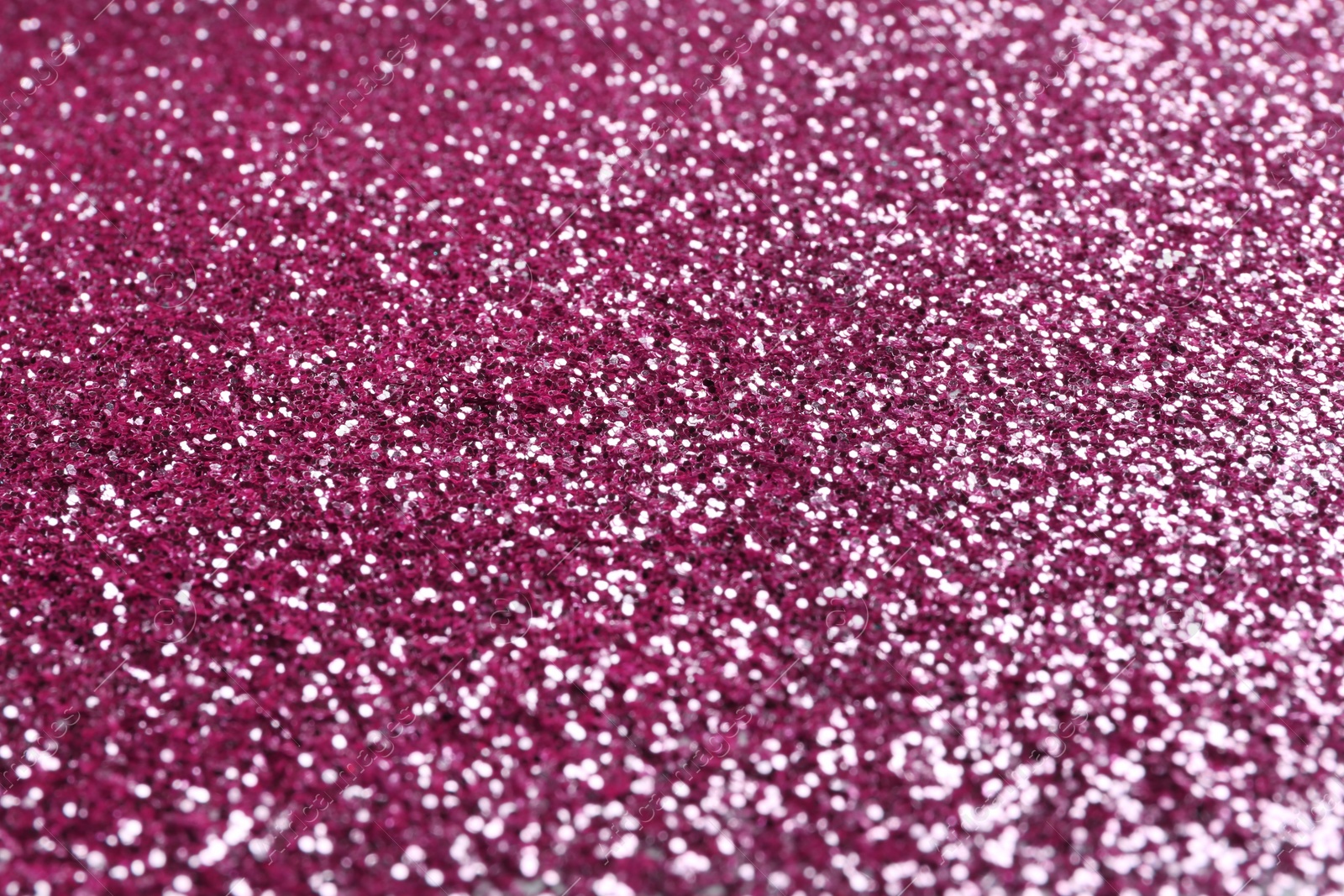 Photo of Closeup view of sparkling pink glitter background