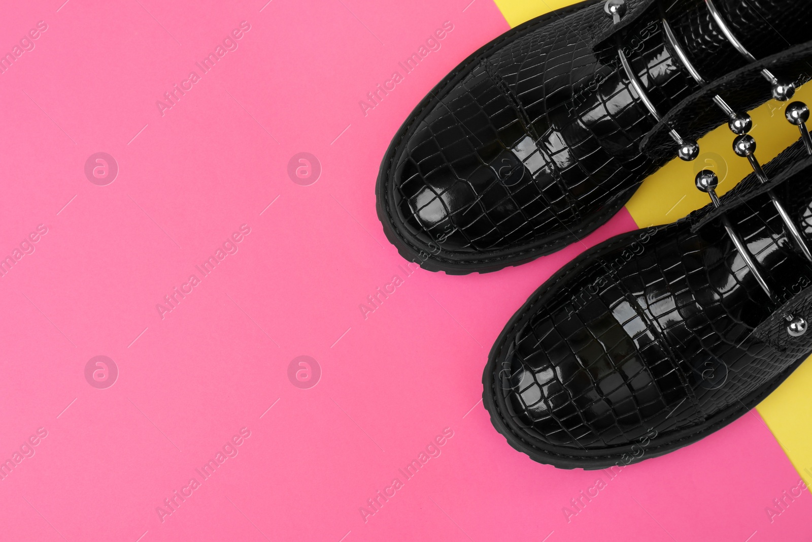 Photo of Pair of stylish ankle boots on color background, top view. Space for text