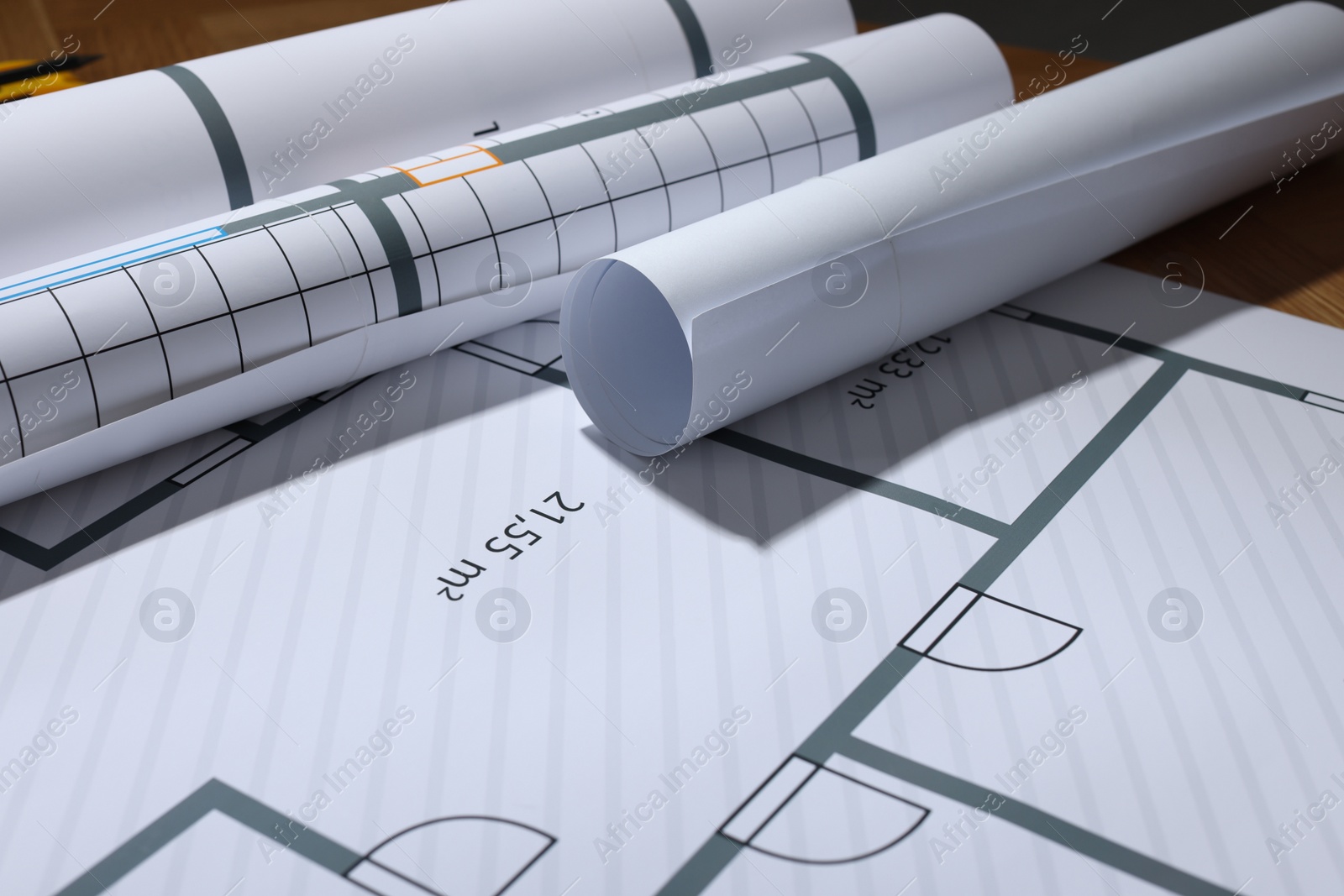 Photo of Many construction drawings on table, closeup view