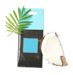 Photo of Scented sachet, green leaf and piece of coconut on white background, top view