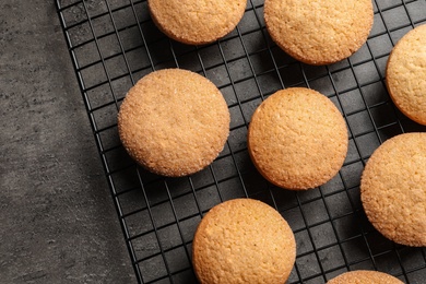 Photo of Baking grid with Danish butter cookies on grey background, top view