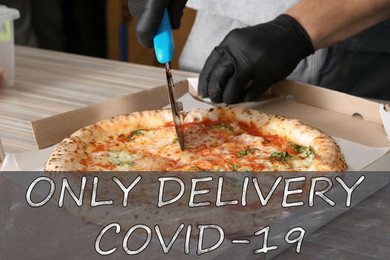 Image of Chef cutting oven baked pizza on table in restaurant, closeup. Online delivery service