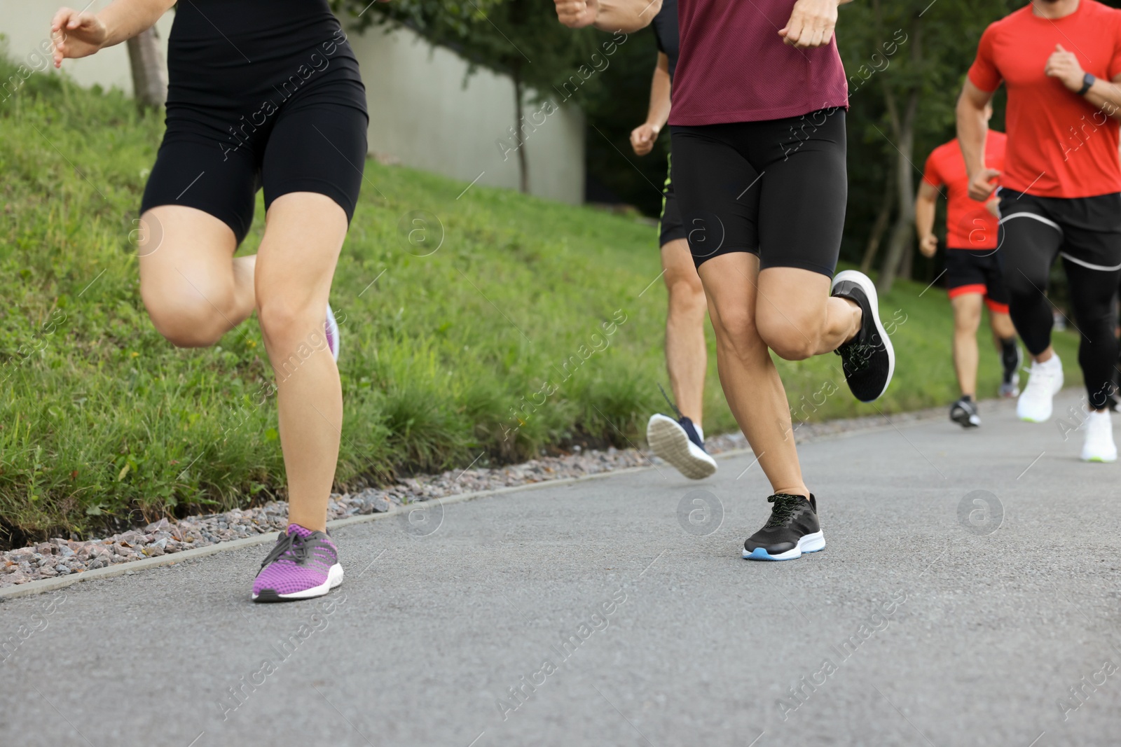 Photo of Group of people running outdoors, closeup view