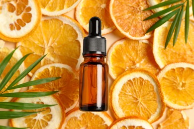 Photo of Flat lay composition with bottle of organic cosmetic product and orange slices on beige background