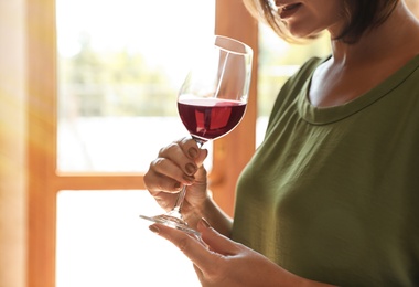 Photo of Woman with glass of red wine indoors